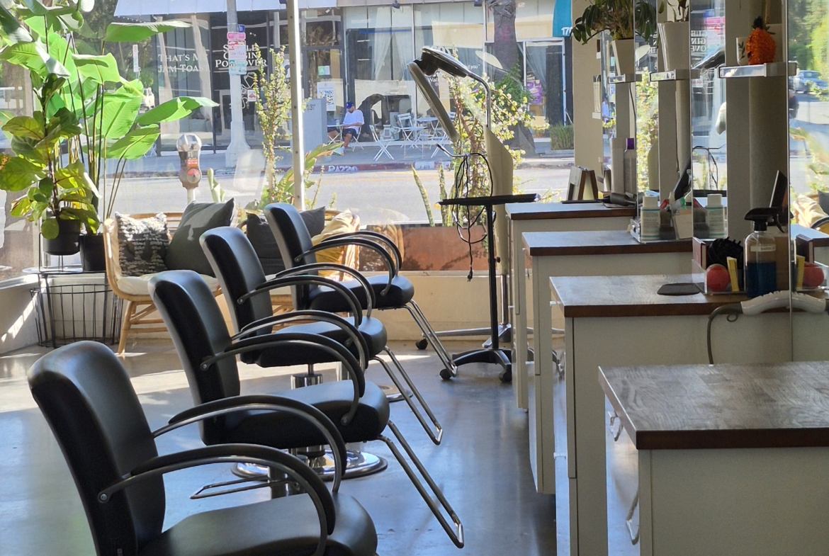 Modern salon chairs in a bright, inviting hair salon interior with natural sunlight.