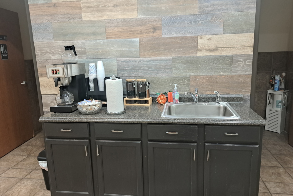Clean, professional salon workspace with coffee and hand sanitizer station.