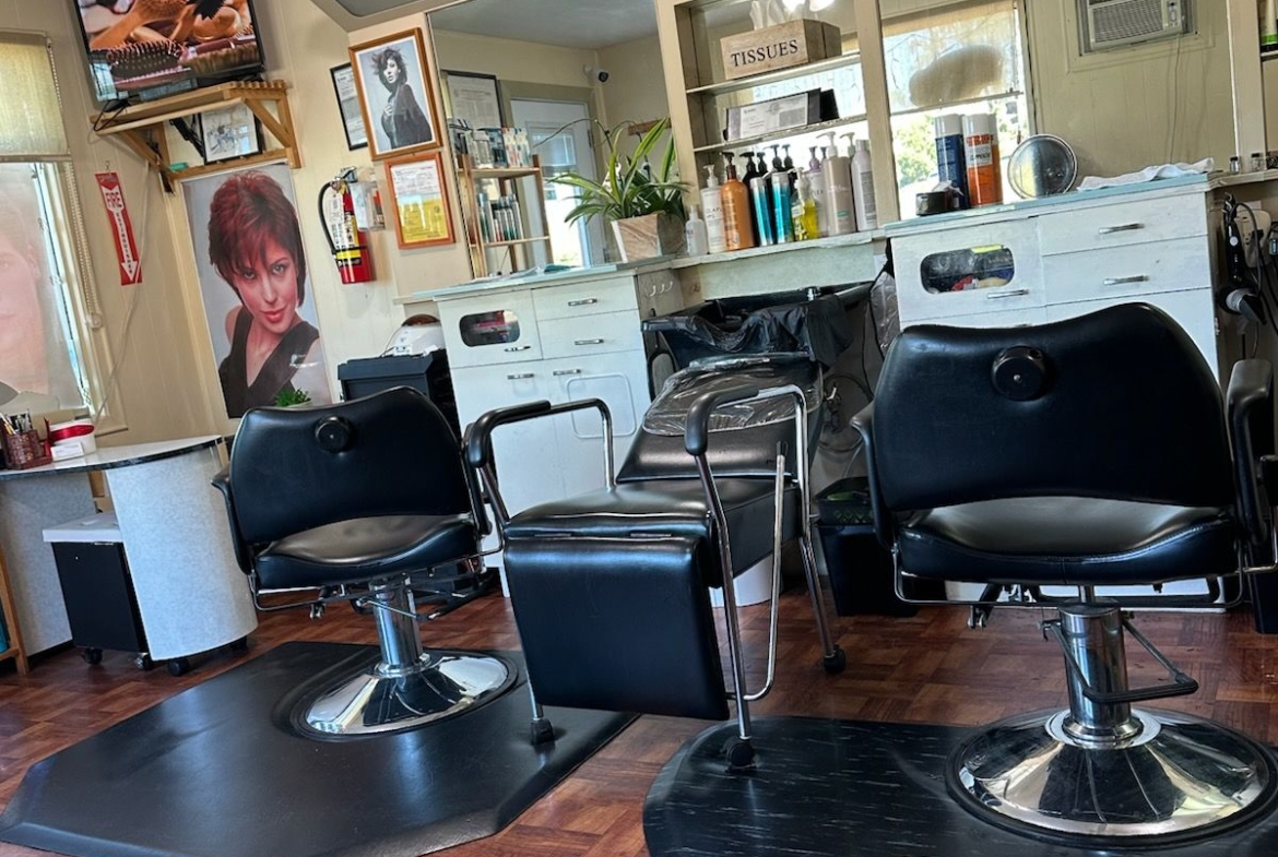 Well-lit hair salon with styling chairs, mirrors, and hair product shelves for rent and hairstyling services.