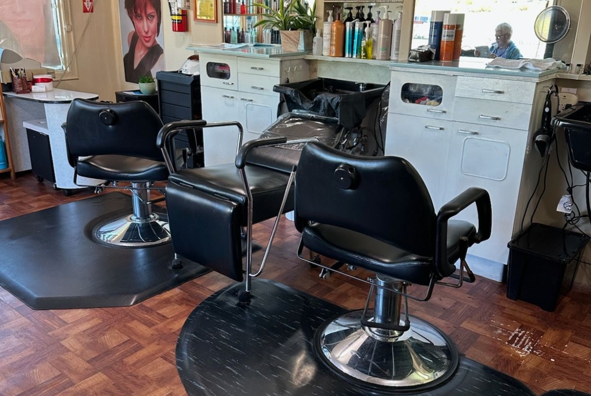 Stylish salon chairs and hair products in a professional salon rental space.
