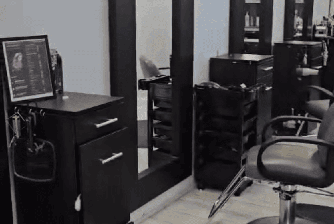 Modern salon station with styling chairs and mirrors for hairdressing.