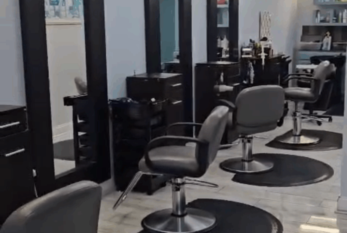 Stylish salon station with modern chairs and mirrors for hair styling and beauty services.