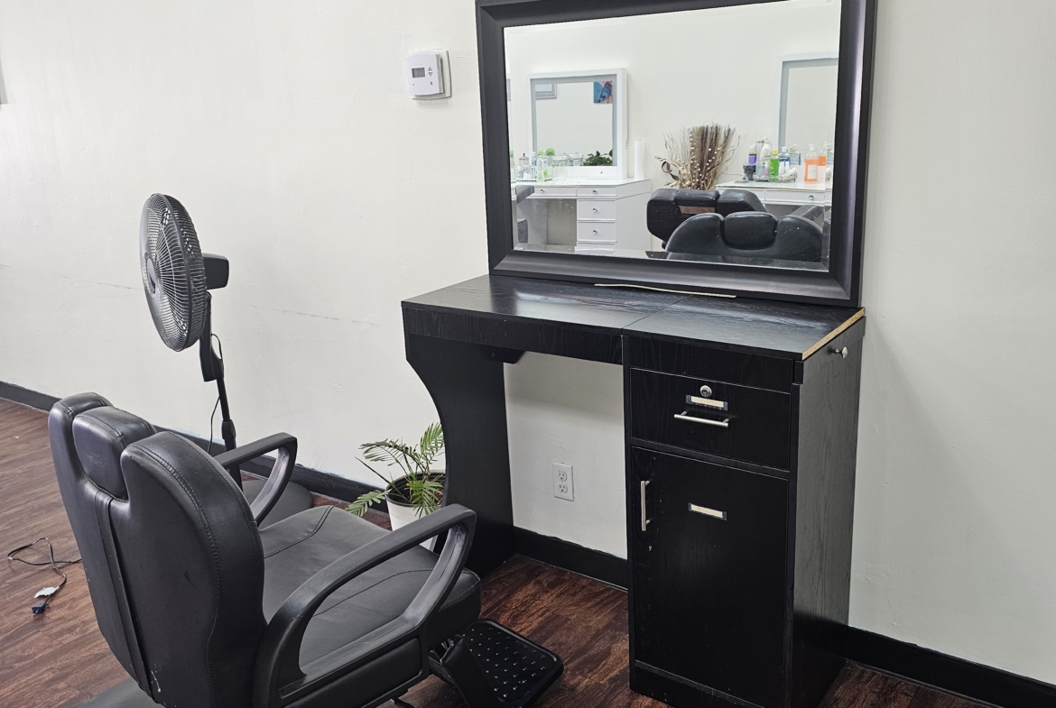 Stylish hair salon station with chair, mirror, and workspace for hair professionals. Perfect for rental salons or stylist setups.