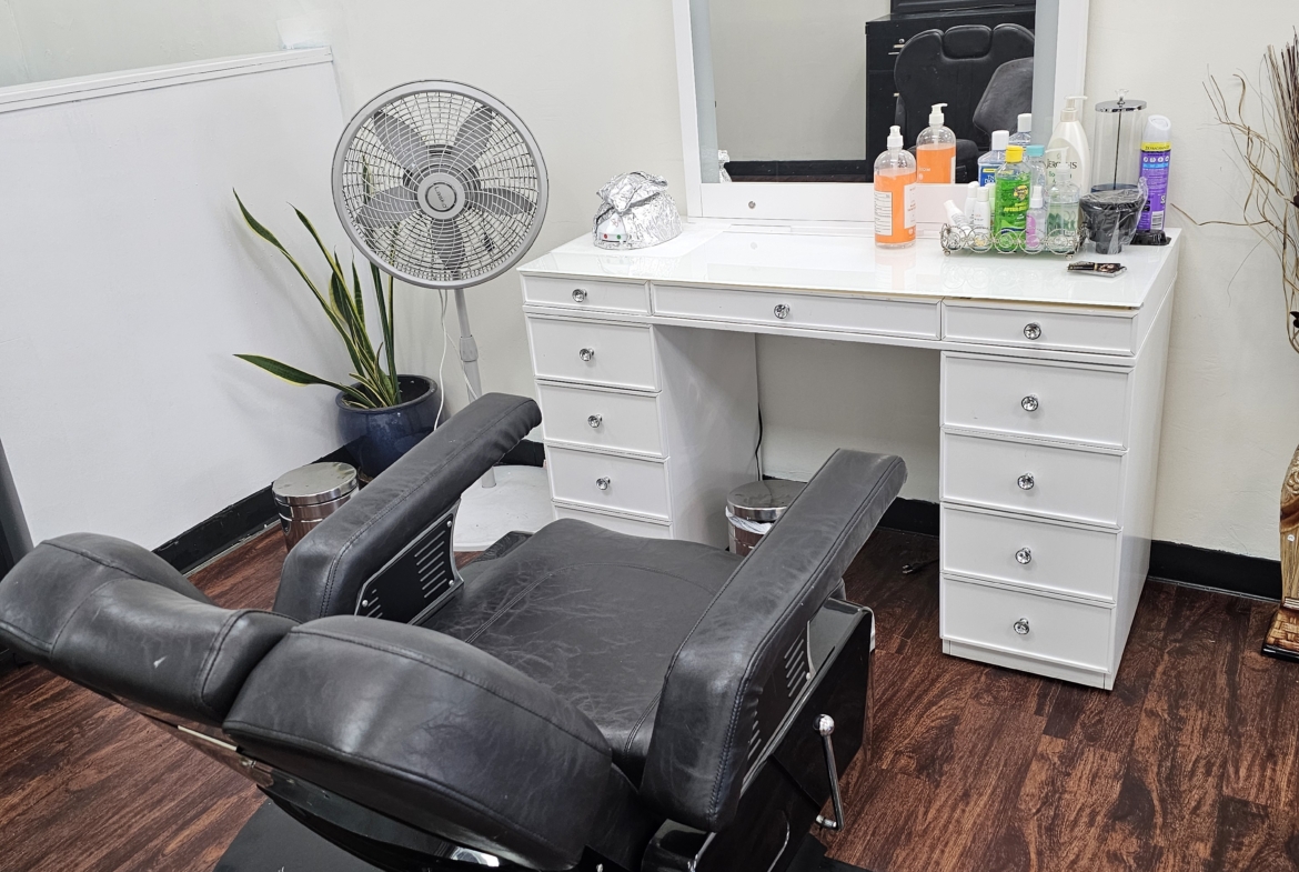 Clean salon vanity with styling tools and products, professional environment for stylists.