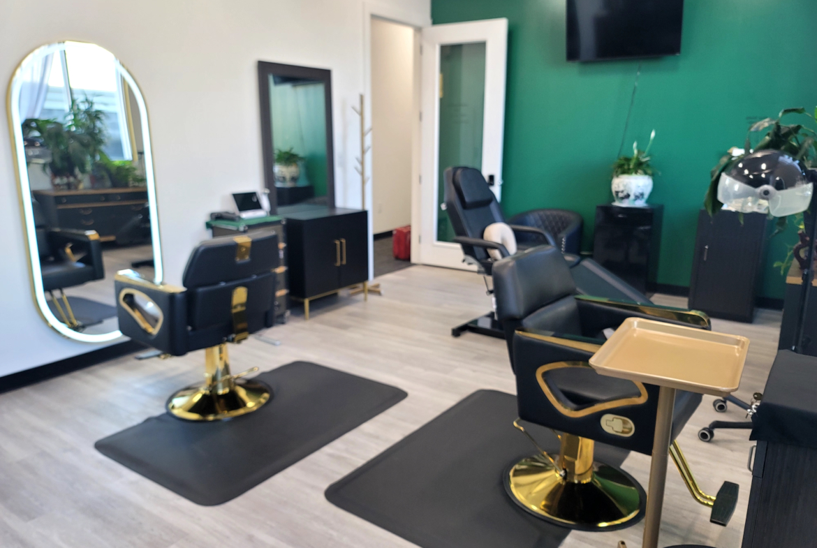 Modern salon interior with styling chairs, mirrors, and greenery for hair salon rental.