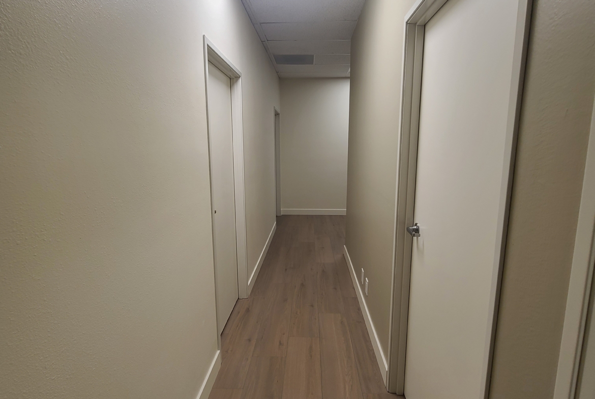 Clean, professional hallway in a salon or spa with multiple doorways, ideal for salon rental businesses.