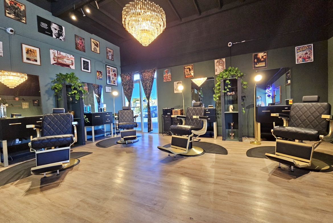Stylish salon with black chairs, mirrors, and vibrant decor for hair and beauty services.