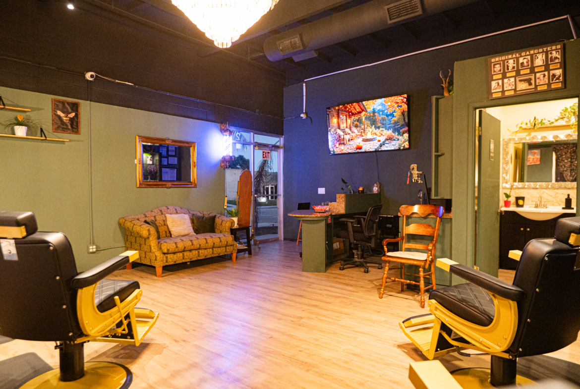 Stylish salon with hairdressing chairs, lounge space, and vibrant wall art for a welcoming atmosphere.