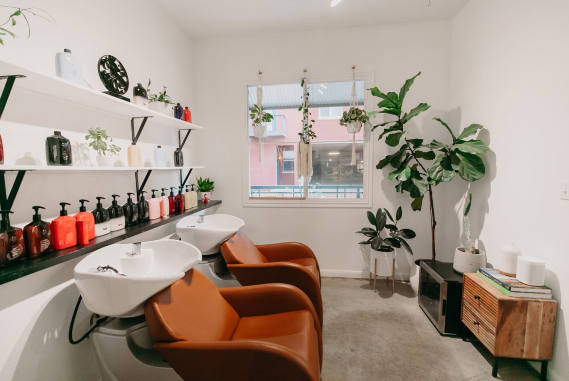 Relaxing salon shampoo station with comfortable chairs and stylish decor for a premium customer experience.