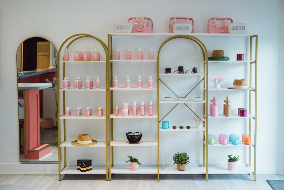 Bright, stylish salon retail display unit featuring hair care, skincare, and accessories in a chic setting.