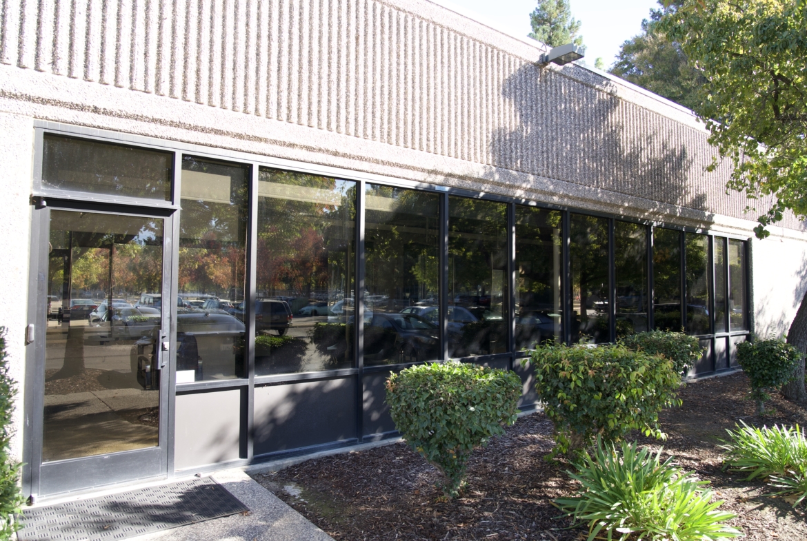 Modern salon storefront with climate-controlled salon spaces, ample parking, and outdoor landscaping.
