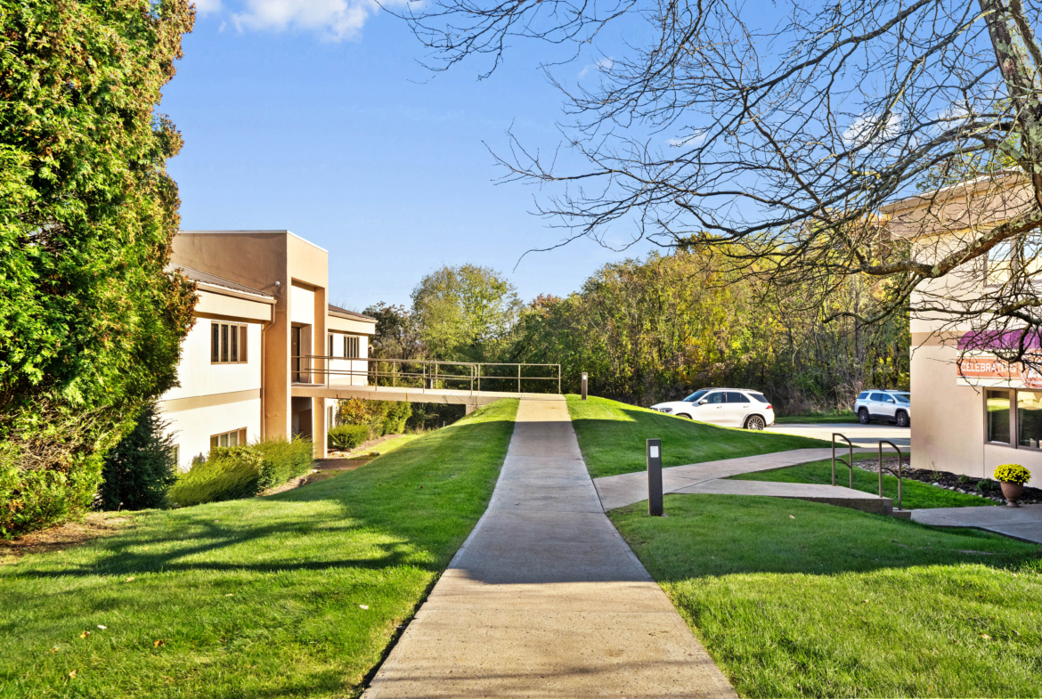 Bright, modern office building with accessible pathways and parking, ideal for salon and business rentals.