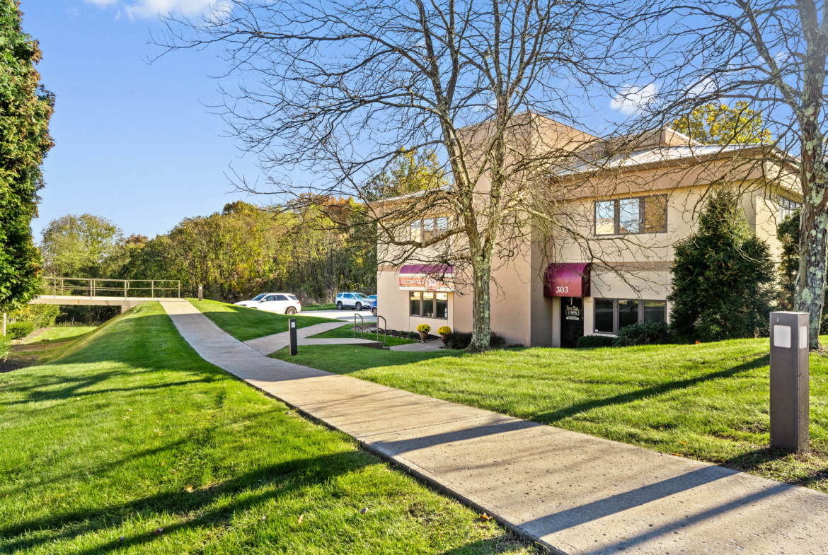 Modern salon rental building with accessible sidewalk and parking spaces.