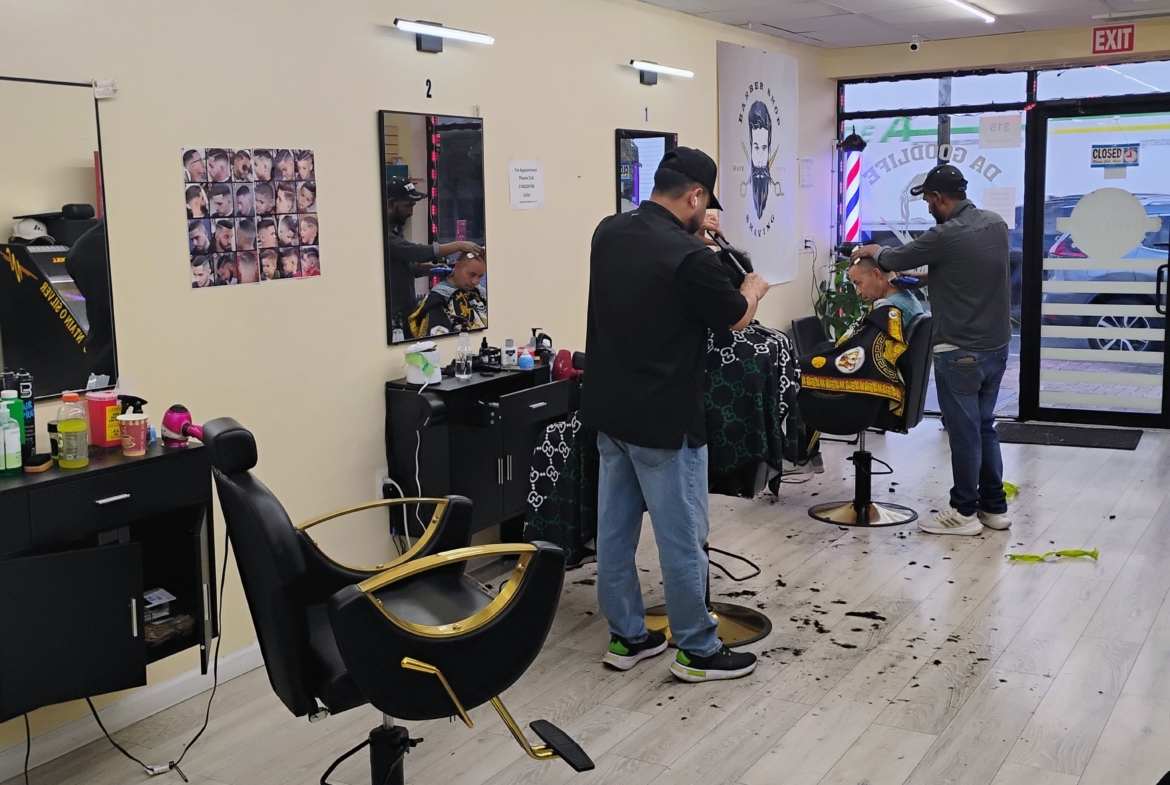 High-quality barber salon with clients enjoying grooming services in a stylish, well-lit setting.
