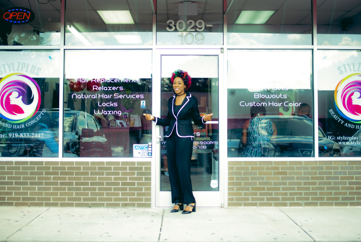 Beauty salon storefront exterior with bright signage and colorful logo.
