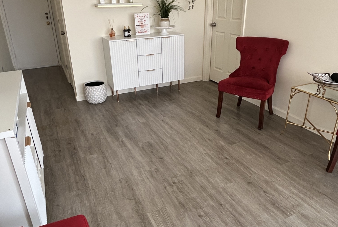 Elegant salon rental interior featuring comfortable seating and decorative wall shelves.