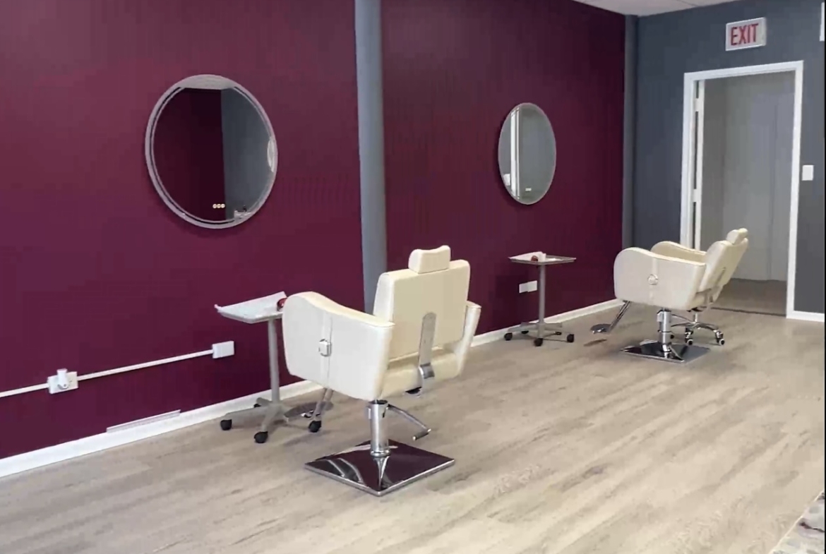 Clean salon station with chairs, mirrors, and workspace for rent or lease.