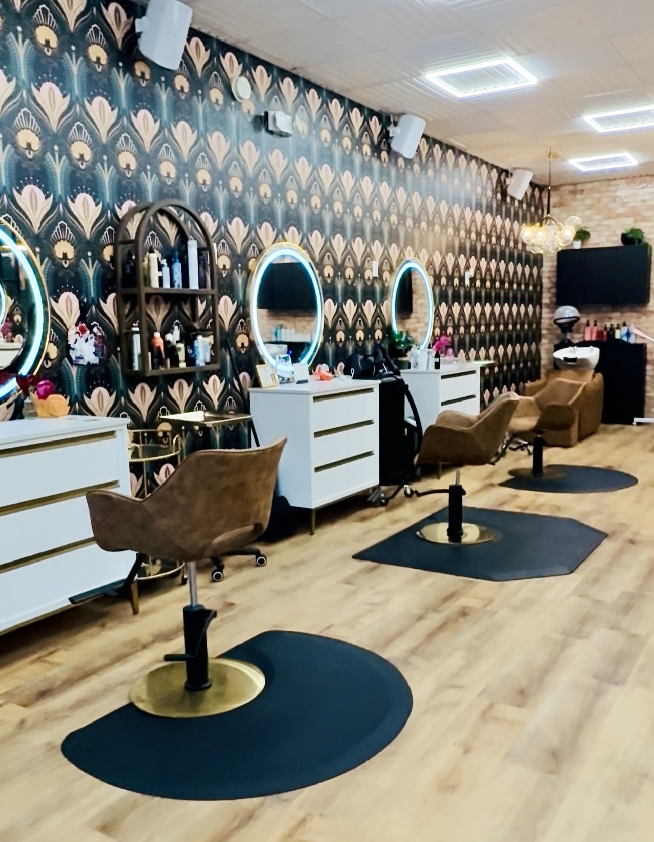 Stylish salon with illuminated mirrors and cozy chairs.