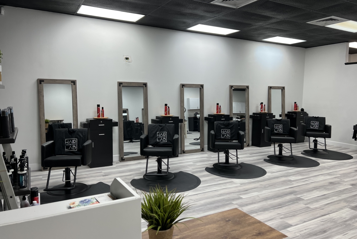 Stylish salon chairs and mirrors in a modern rental space for hair professionals.