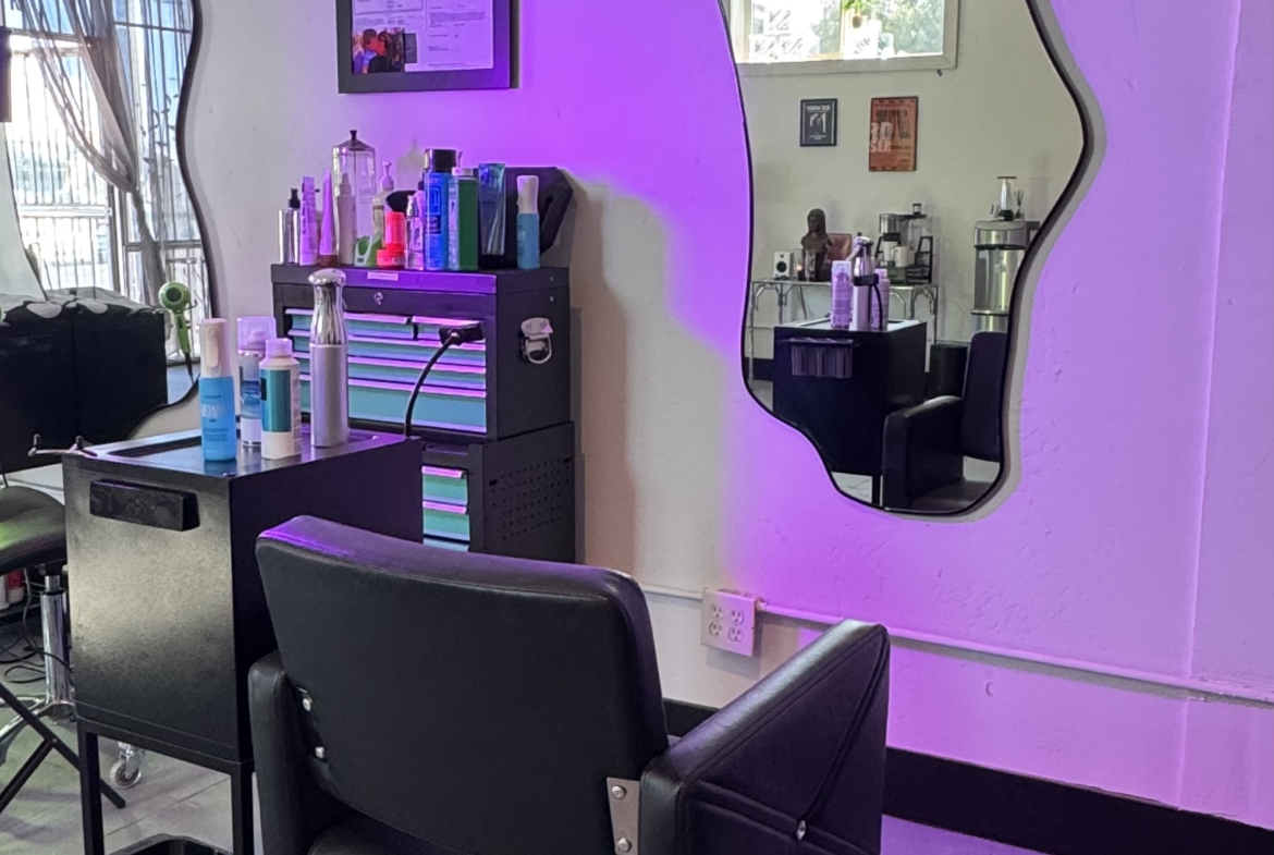 Stylish salon mirror with modern decor, hairdressing station, and professional equipment.