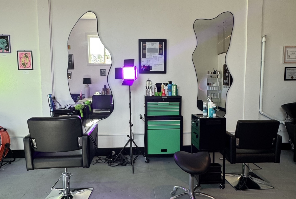 Bright salon workspace with stylish mirrors, styling chairs, and professional hairdressing tools.
