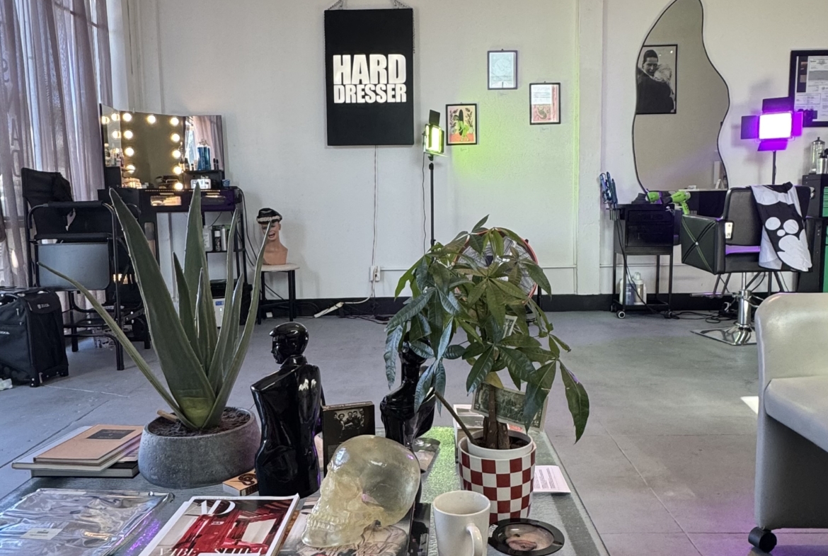 Bright and modern salon space featuring makeup stations, decorative elements, and a comfortable atmosphere.