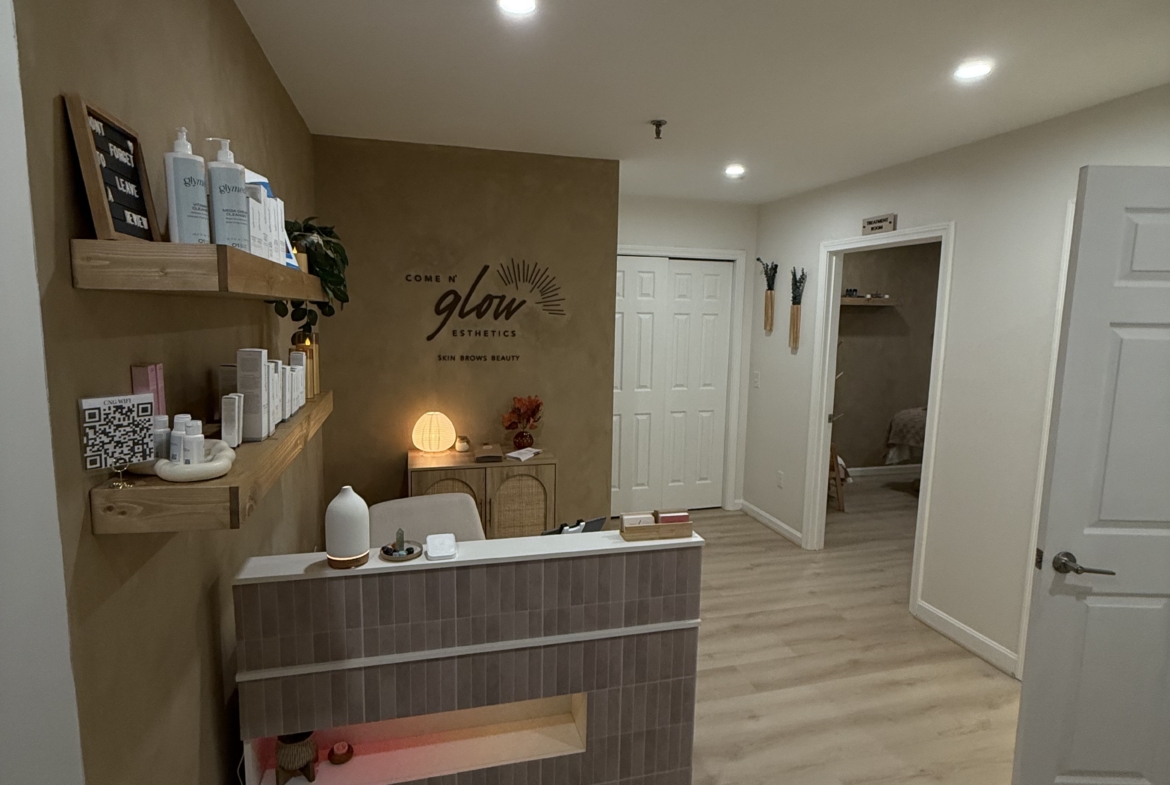 Bright and welcoming salon front desk with organized shelves and cozy ambiance.