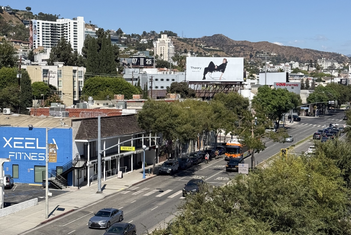 Bright, sunny day with clear blue sky and rolling hills in the background.
