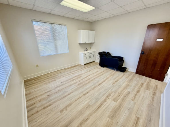 Bright salon rent space featuring natural light, hardwood floors, and essential salon amenities.