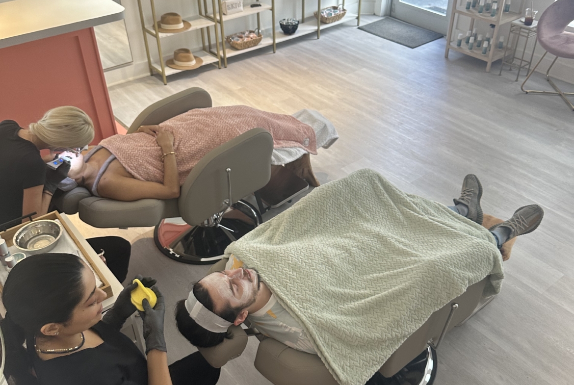 Elegant beauty salon interior with relaxing treatment chairs and shelves of beauty products.