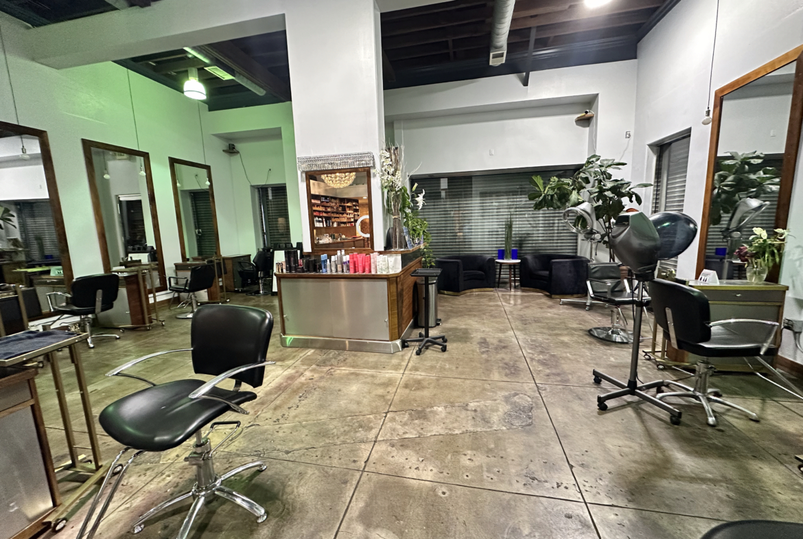 Bright salon with multiple styling chairs, mirrors, and a relaxing waiting area for clients.