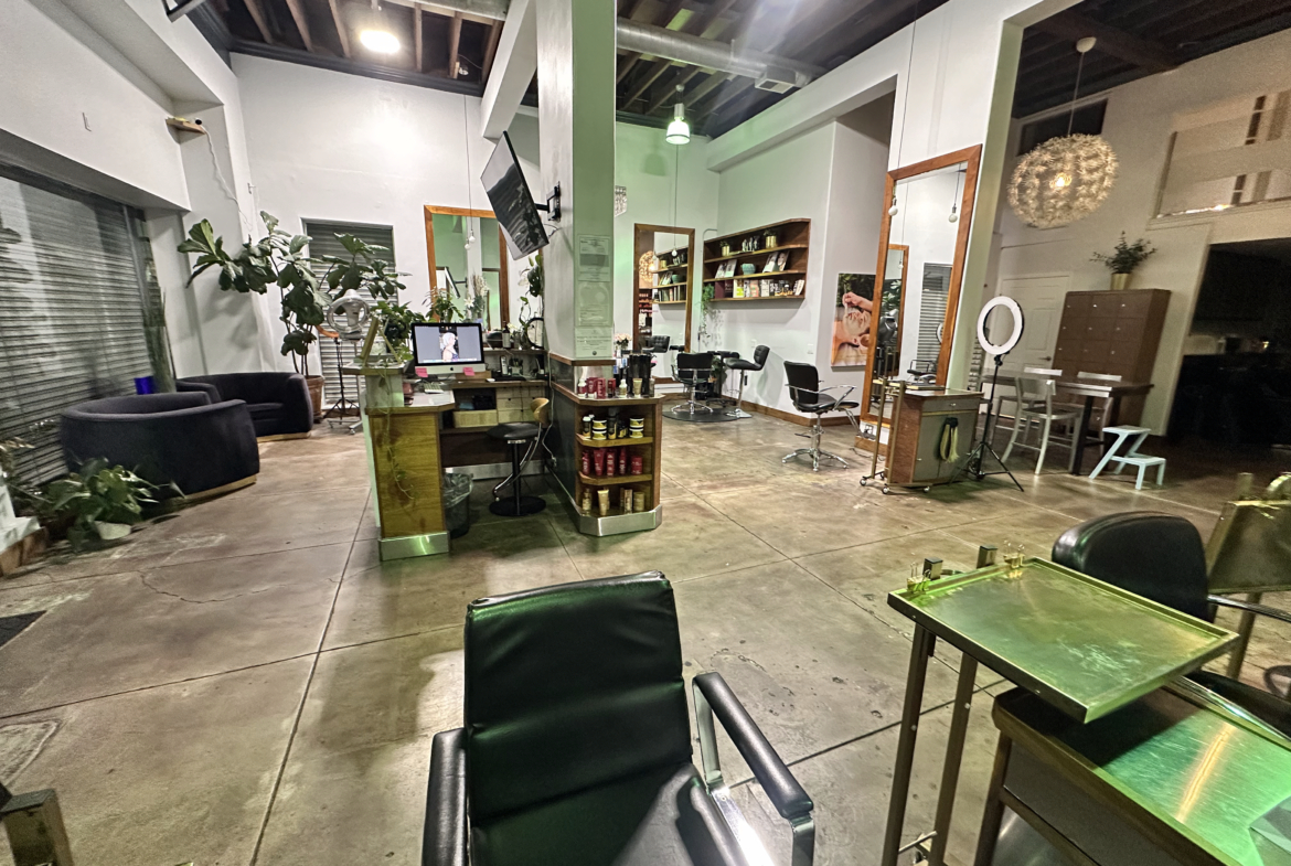 Bright, spacious salon interior with professional styling stations and inviting lounge space.