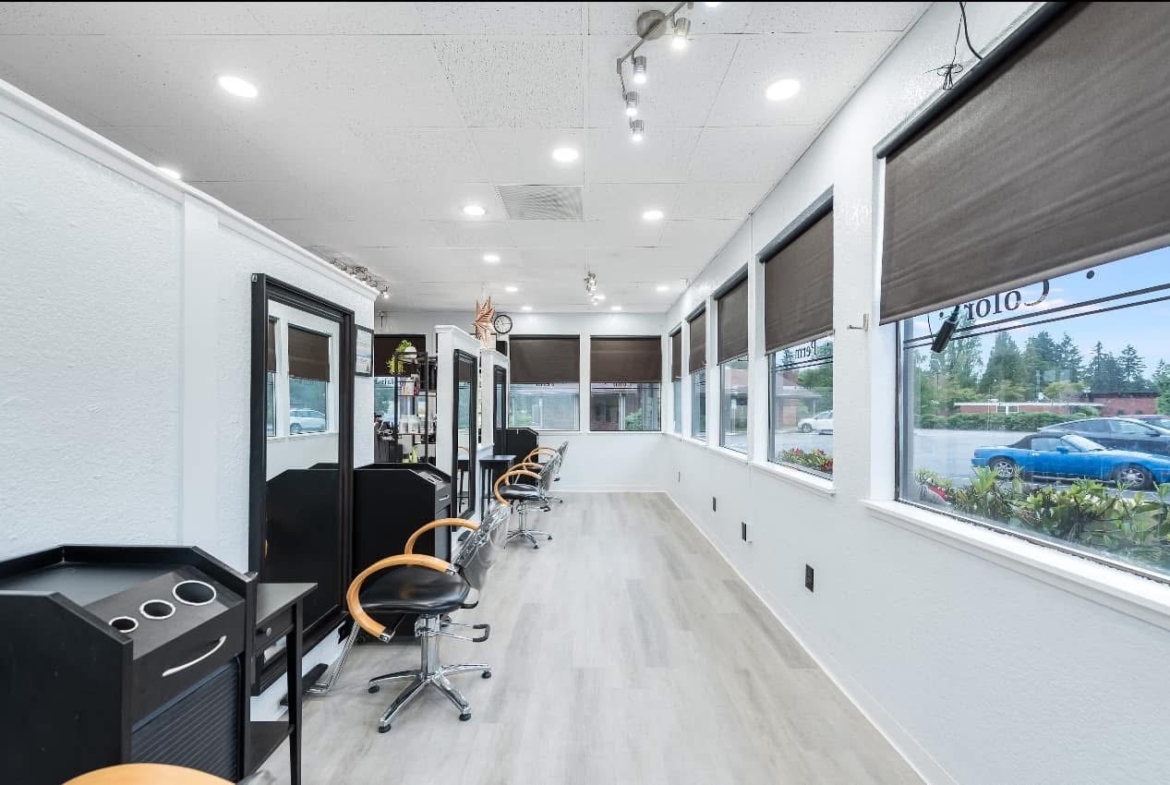 Bright salon with multiple styling stations and large windows for natural light.