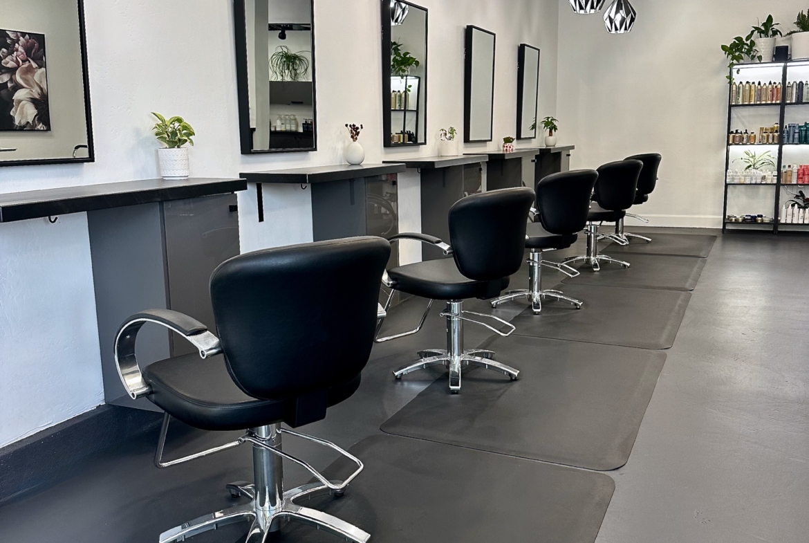 Professional salon chair setup with mirrors and decor, ideal for haircutting and styling services.