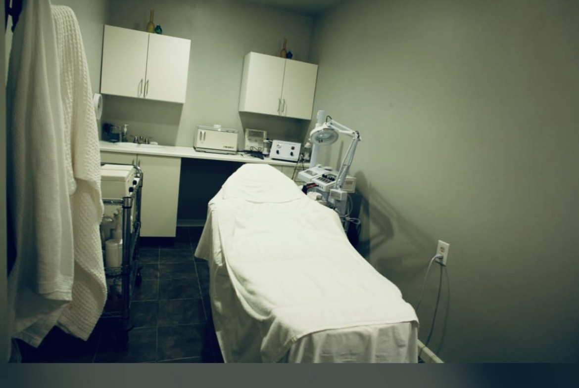 Clean medical treatment room with examination bed and modern equipment.