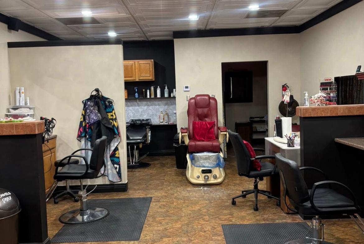 Stylish salon with chairs, workstations, and a massage chair for hair and beauty treatments.