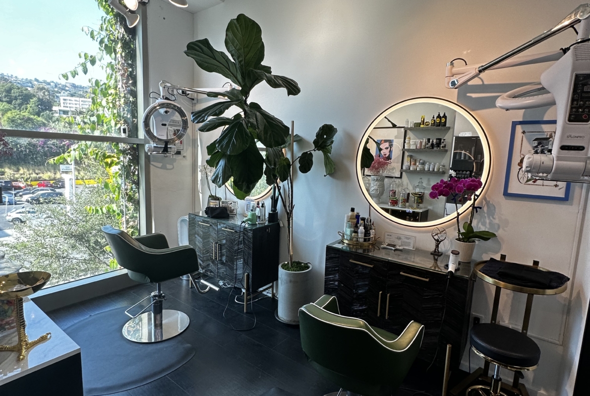 Bright and stylish salon interior featuring hair styling chairs, large window, and modern decor.