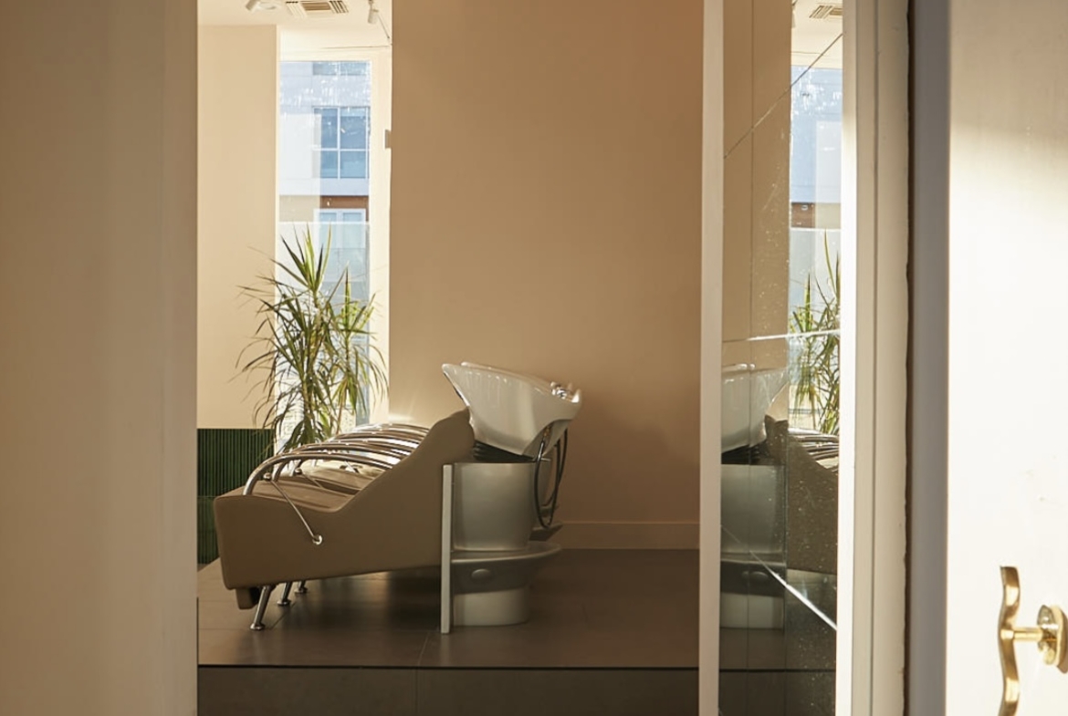 Versatile salon space featuring a hair wash station and contemporary design.