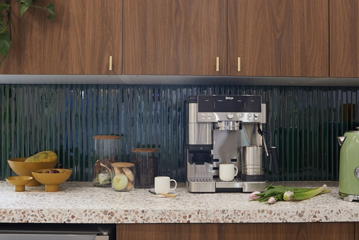 Bright salon space featuring coffee equipment and stylish wooden cabinets.