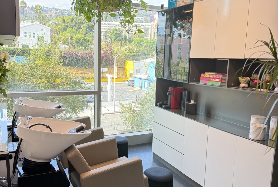 Luxurious salon wash area with comfortable chairs and natural light for a relaxing client experience.