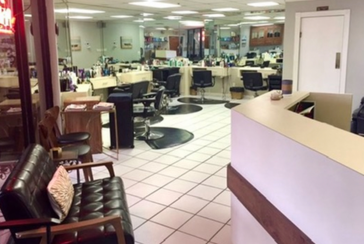 Clean, modern salon workspace with styling chairs, countertops, and equipment for rent.