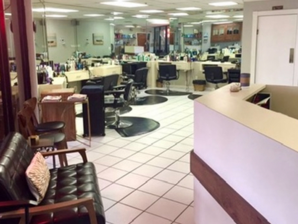 Clean, modern salon workspace with styling chairs, countertops, and equipment for rent.