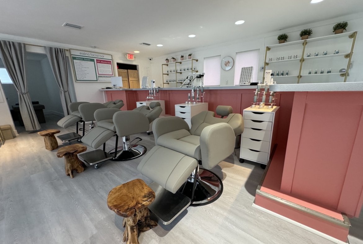 Comfortable salon chairs and natural wood stools in a bright, trendy beauty salon.