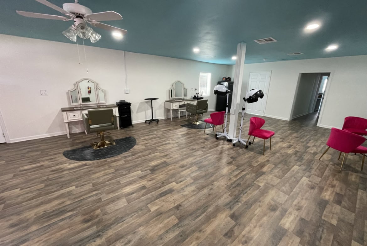 Bright salon space with hair styling stations, pink chairs, and modern equipment—perfect for salon renting.