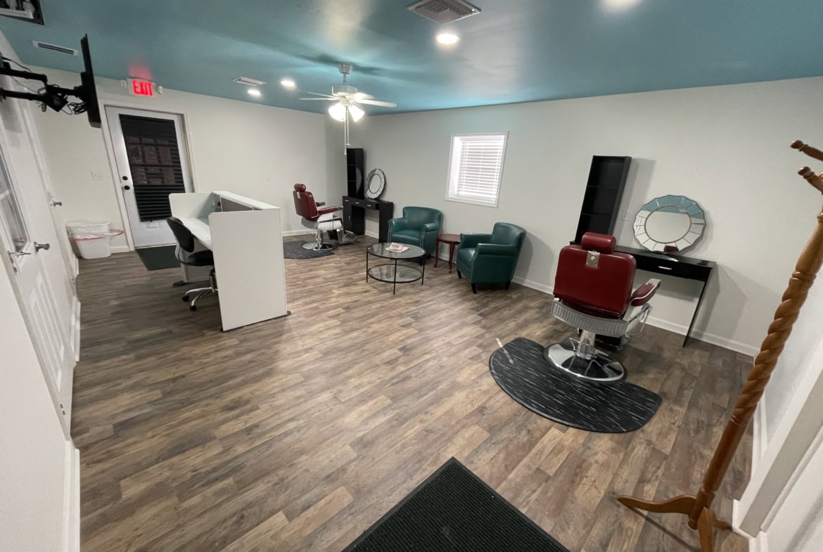 Spacious salon waiting area with vintage barber chairs and modern decor, perfect for salon rentals.