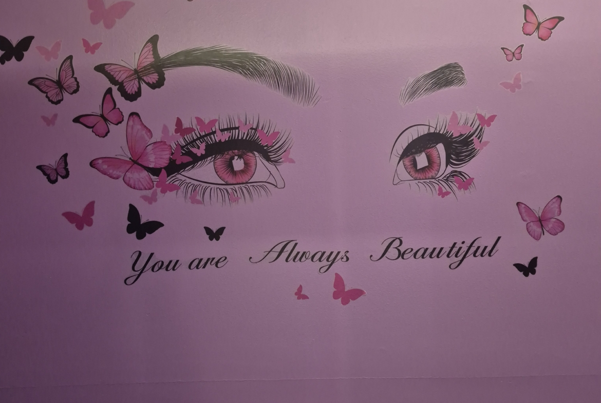 Colorful butterfly wall decor with illustrated eyes and uplifting quote "You are Always Beautiful". Key for salon interior design.