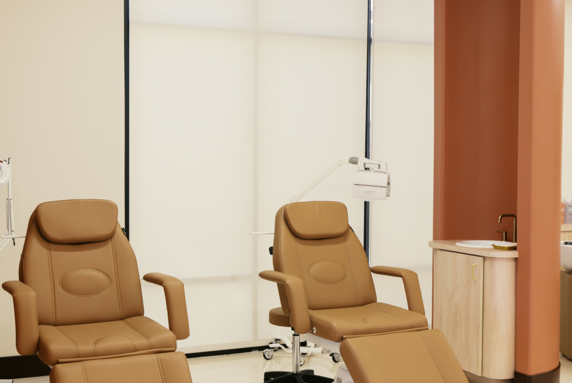 Comfortable salon chairs with footrests in a modern, professional salon rental space.
