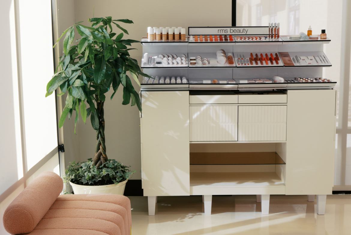 Elegant salon space with beauty product display and cozy seating area.