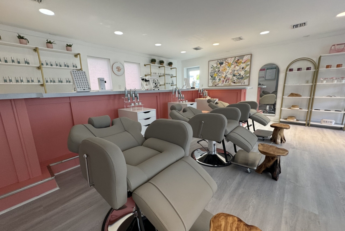 Bright salon with comfortable styling chairs, beauty product displays, and a welcoming atmosphere for clients.