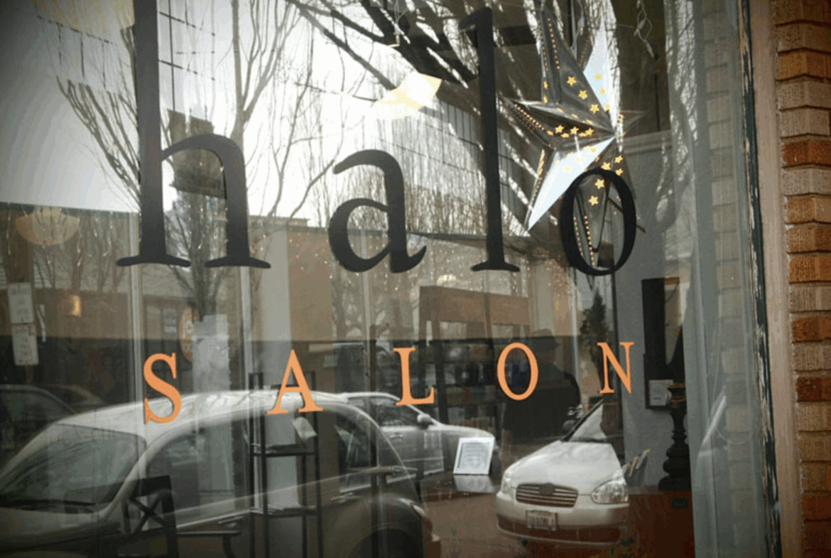 Bright salon storefront with holiday star decorations, promoting professional beauty services.